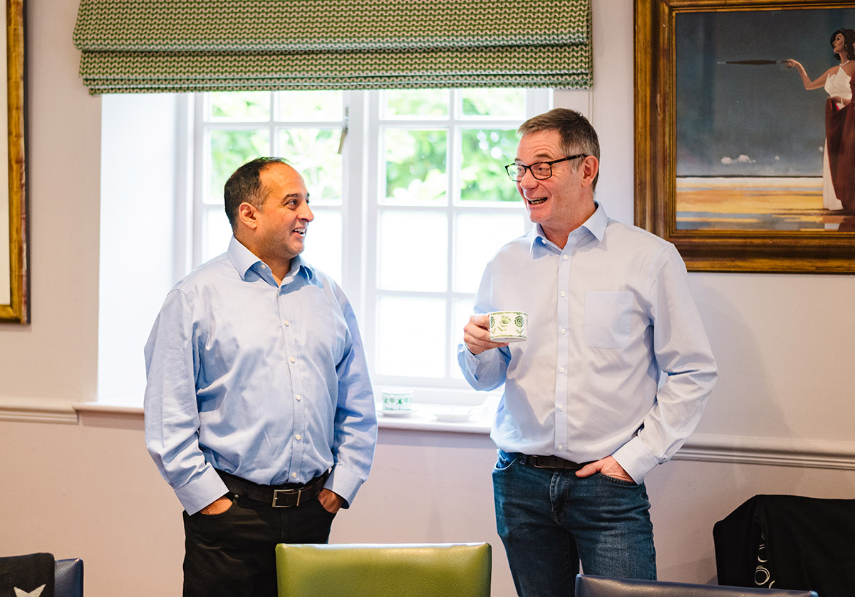 Rupert taling to an attendee at an event