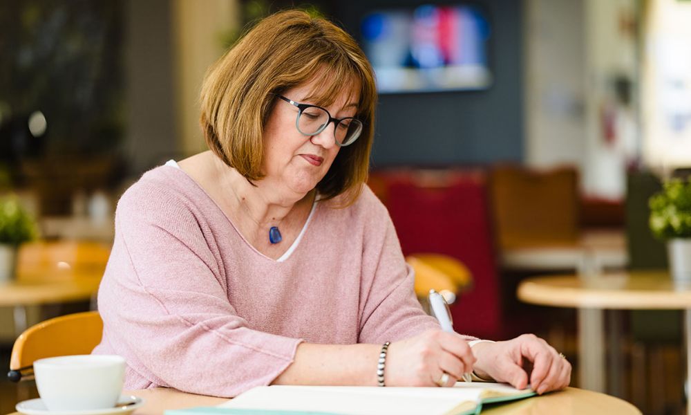 Angela writing on pad