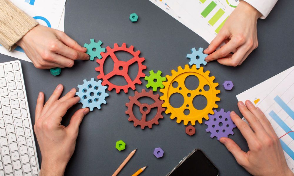 team moving cogs on table