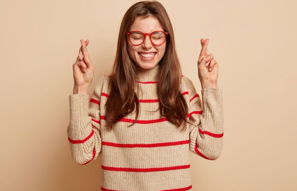 woman with fingers crossed